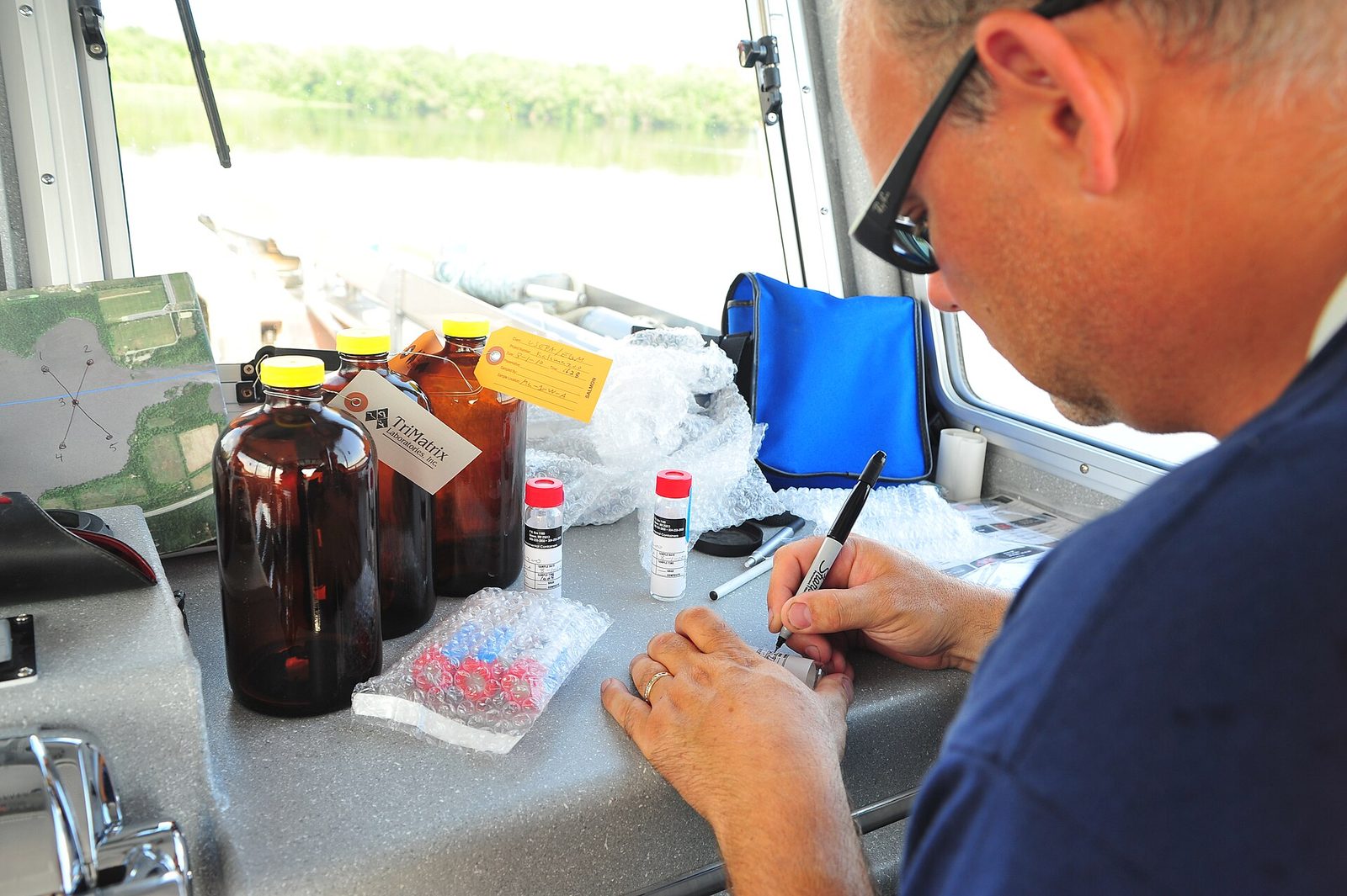 Field technician labeling environmental samples during an EPA spill response.