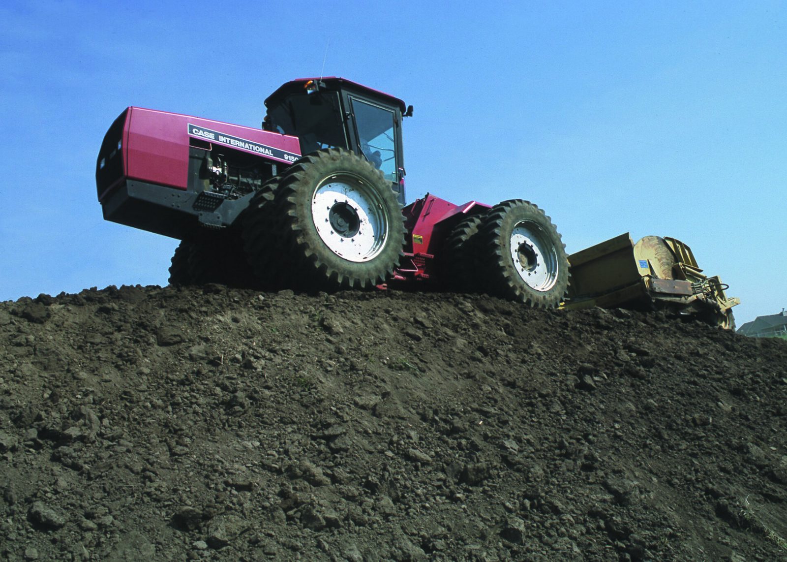 A topsoil stockpile being moved with heavy equipment, Missouri.